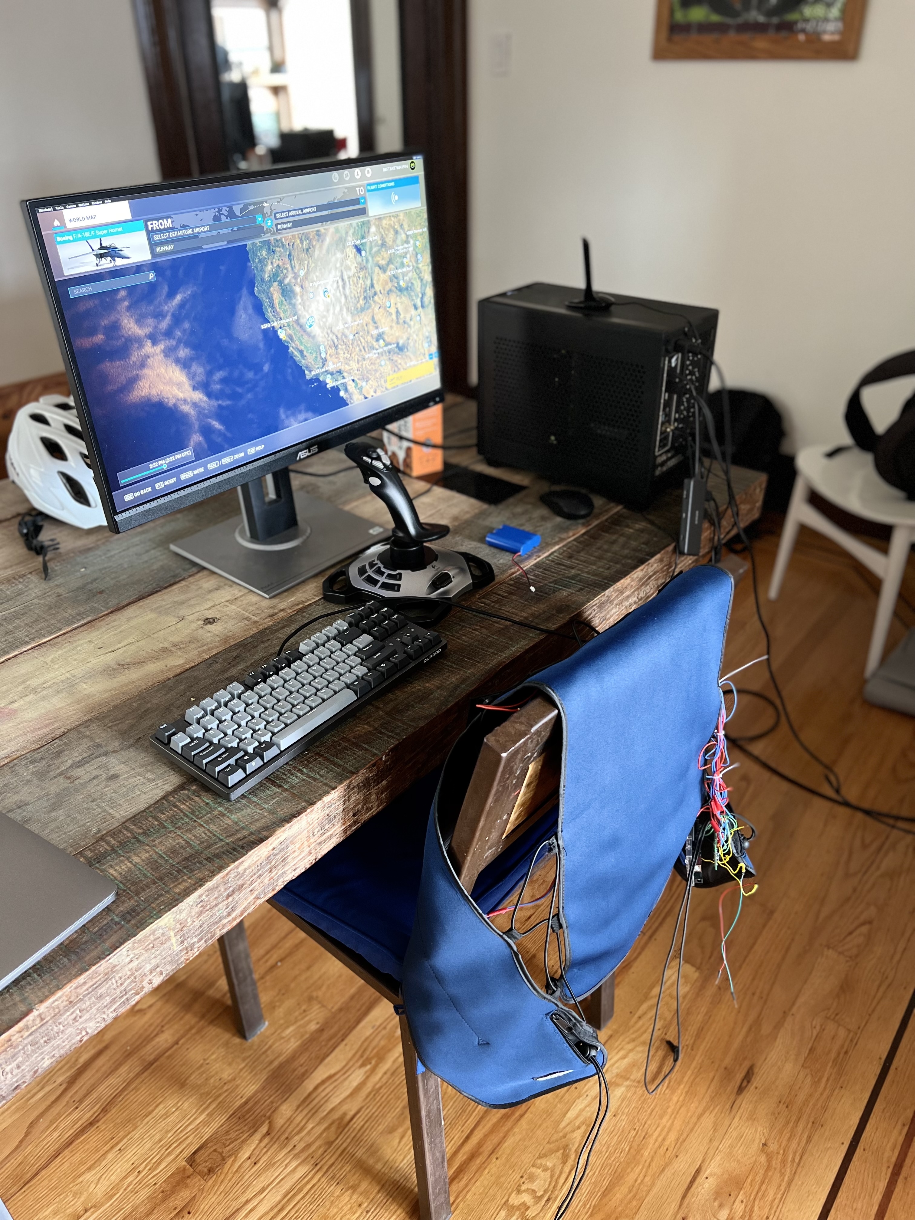 Our flight simulator testing setup, featured prominently in the middle of our dining room table.